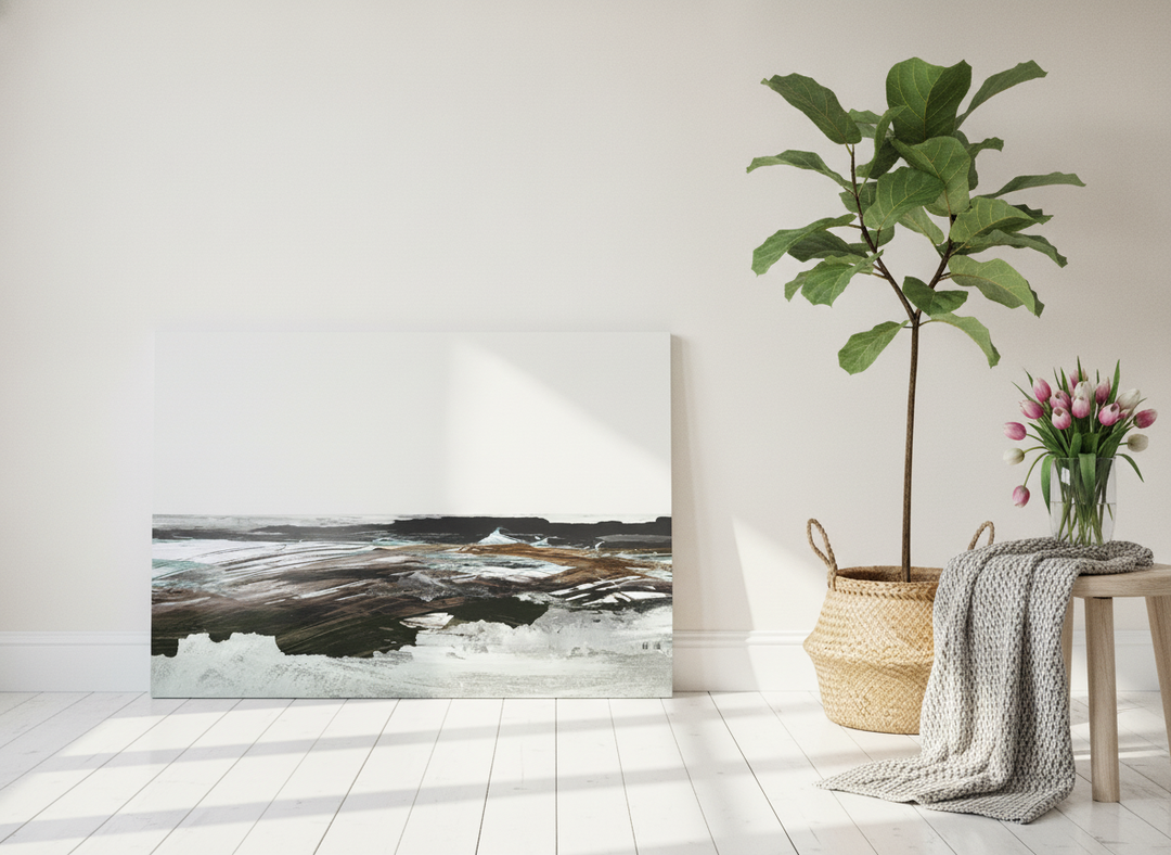 Stretched canvas wall art leaning against the wall in a bright Scandinavian home office