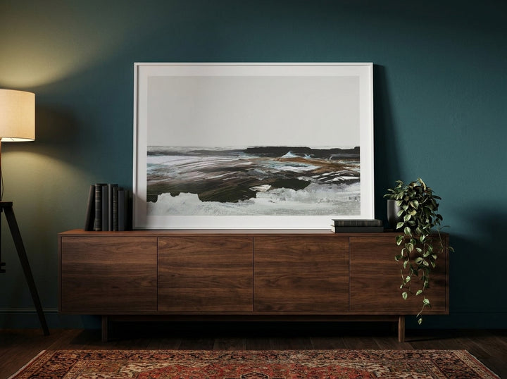 Modern wall art print standing on a sideboard in a moody bedroom