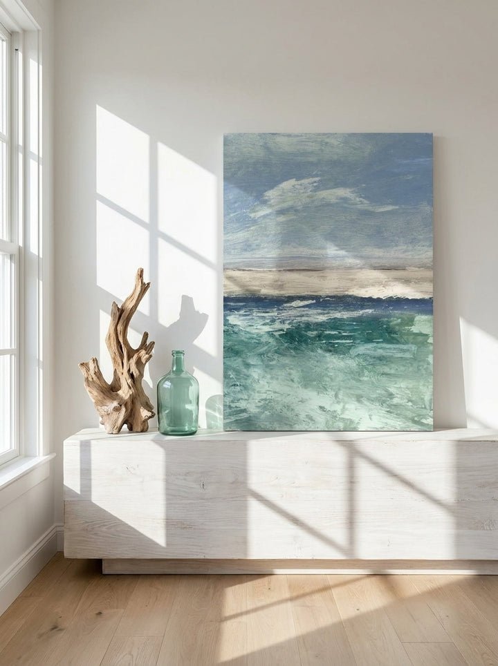 Stretched canvas wall art standing on a console in a coastal living room