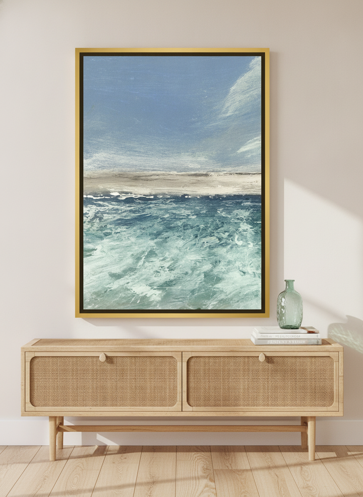 Canvas wall art with a gold leaf surround standing on a sideboard in a coastal living room