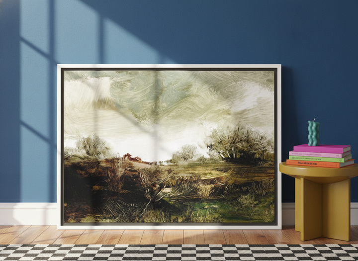 Canvas wall art with a white surround leaning against the wall in a colourful eclectic home office