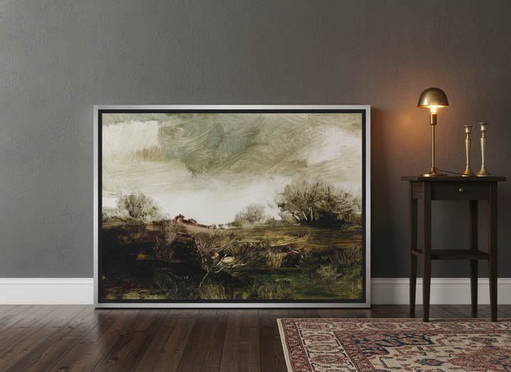 Canvas wall art with a silver leaf surround leaning against the wall in a moody bedroom