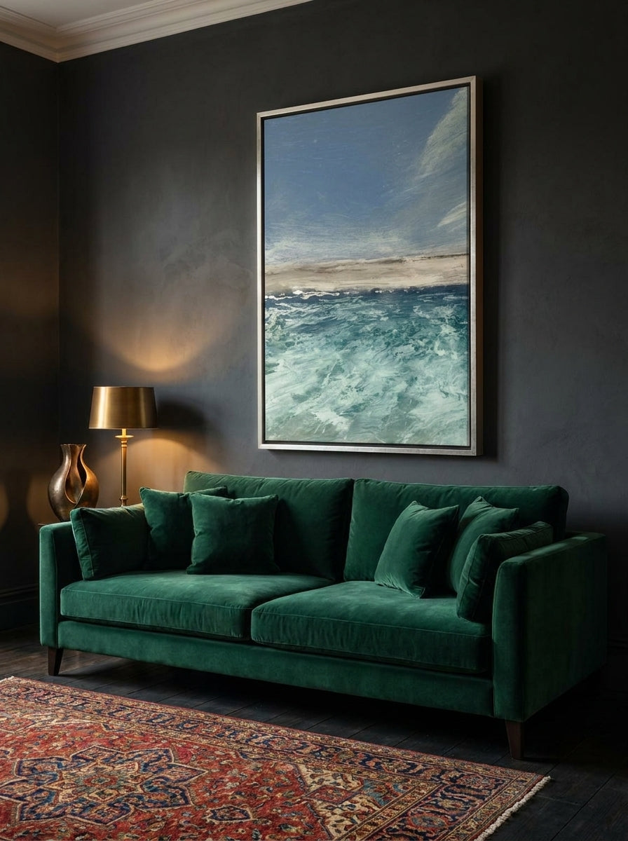 Oversized statement canvas wall art with a silver leaf surround styled on the wall in a moody living room