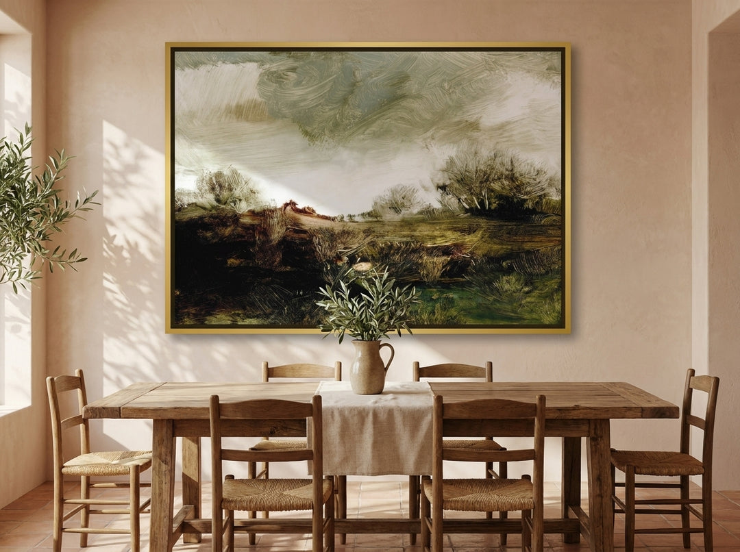 Oversized statement canvas wall art with a gold leaf surround styled on the wall in a Mediterranean dining room