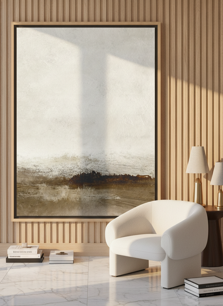 Oversized statement canvas wall art with a natural timber surround leaning against the wall in a luxe living room