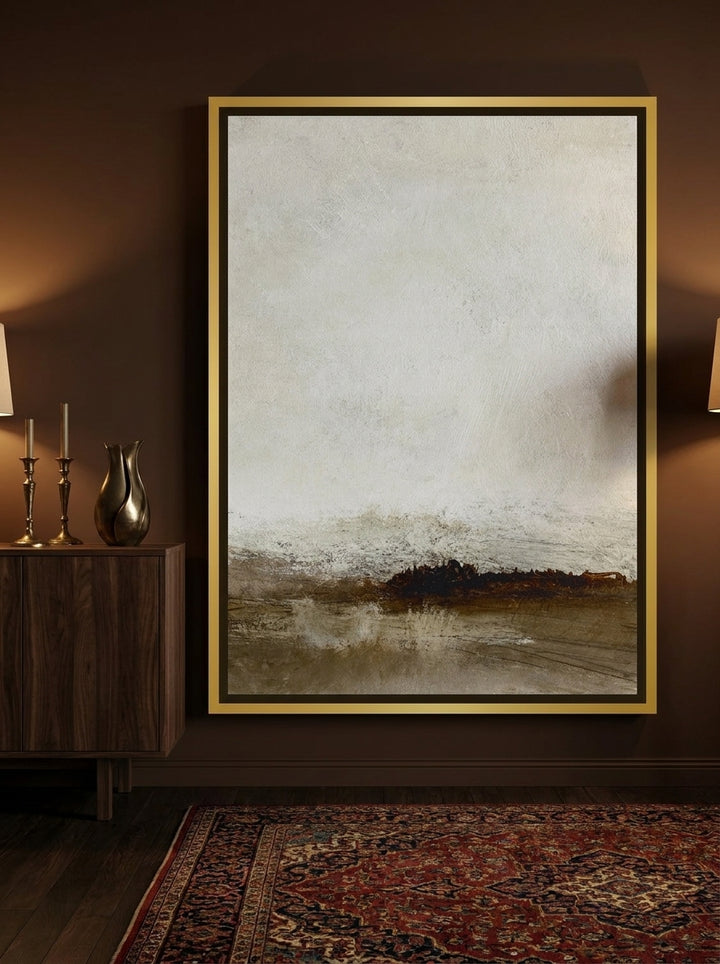 Canvas wall art with a gold leaf surround standing on a sideboard in a moody home office