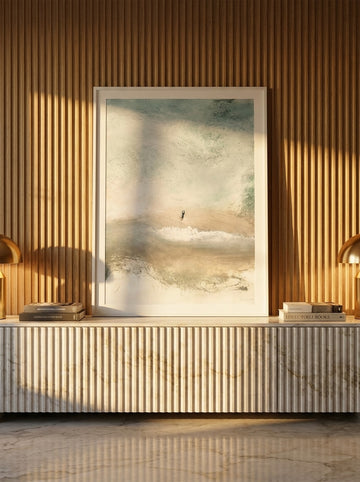 Modern wall art print standing on a sideboard in a luxe living room