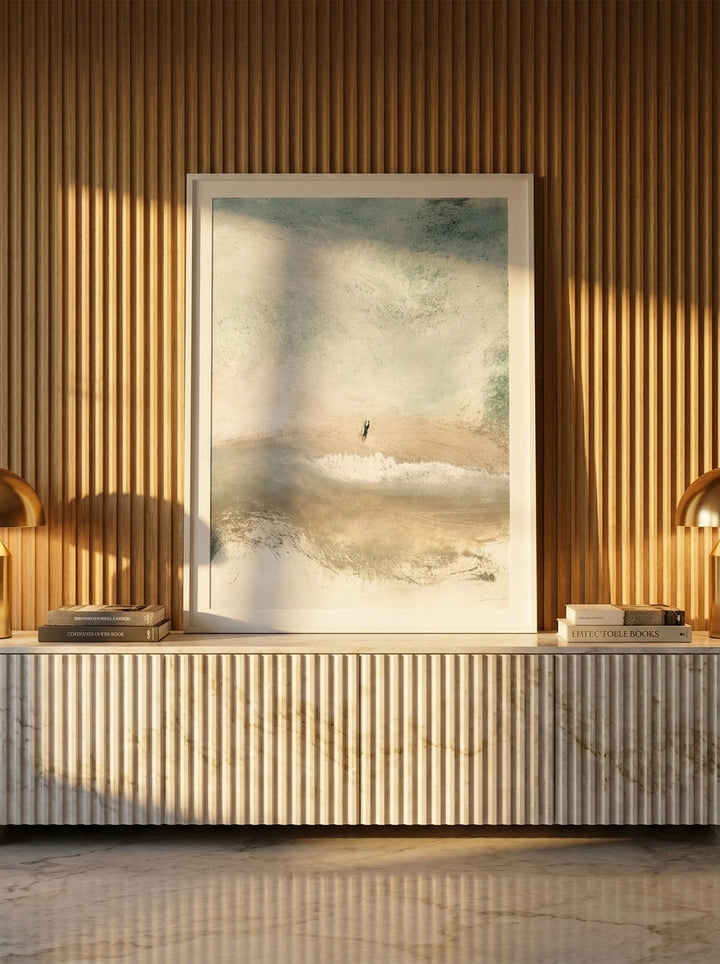 Modern wall art print standing on a sideboard in a luxe living room