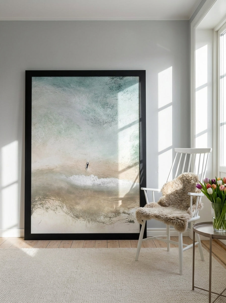 Oversized statement modern wall art print leaning against the wall in a bright Scandinavian living room