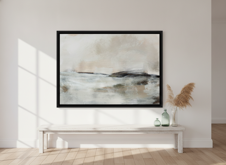 Oversized statement canvas wall art with a black surround styled on the wall in a coastal living room