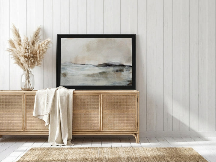 Modern wall art print standing on a sideboard in a coastal bedroom