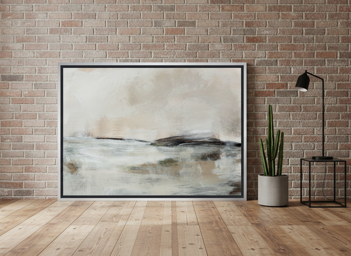 Canvas wall art with a silver leaf surround leaning against the wall in an industrial loft bedroom