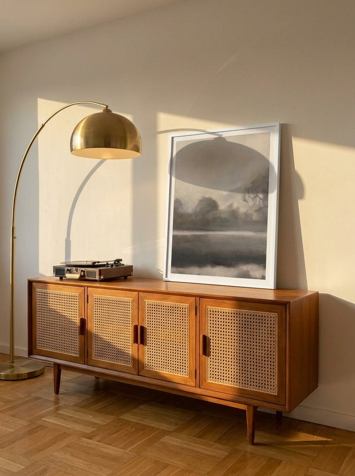 Modern wall art print standing on a sideboard in a mid-century bedroom