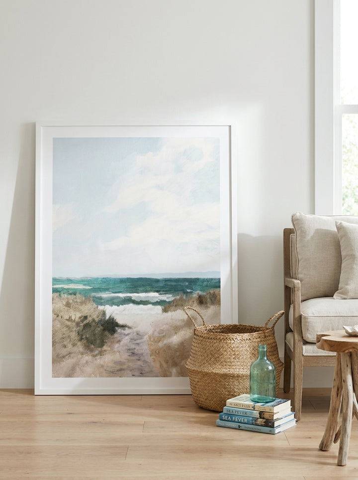 Oversized statement modern wall art print leaning against the wall in a coastal bedroom