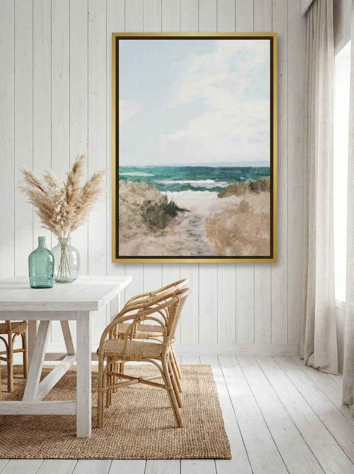 Oversized statement canvas wall art with a gold leaf surround styled on the wall in a coastal dining room