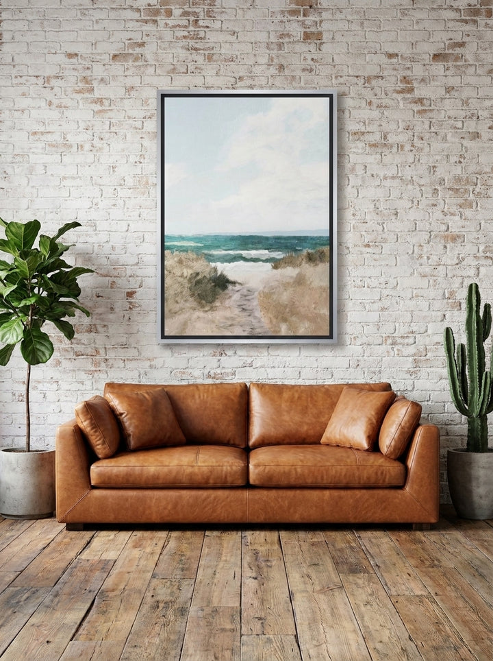 Canvas wall art with a silver leaf surround styled on the wall in an industrial loft living room