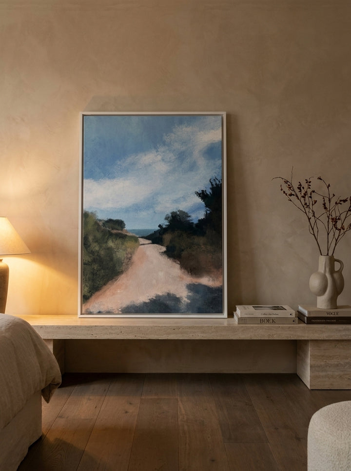 Canvas wall art with a white surround standing on a console in a luxe bedroom