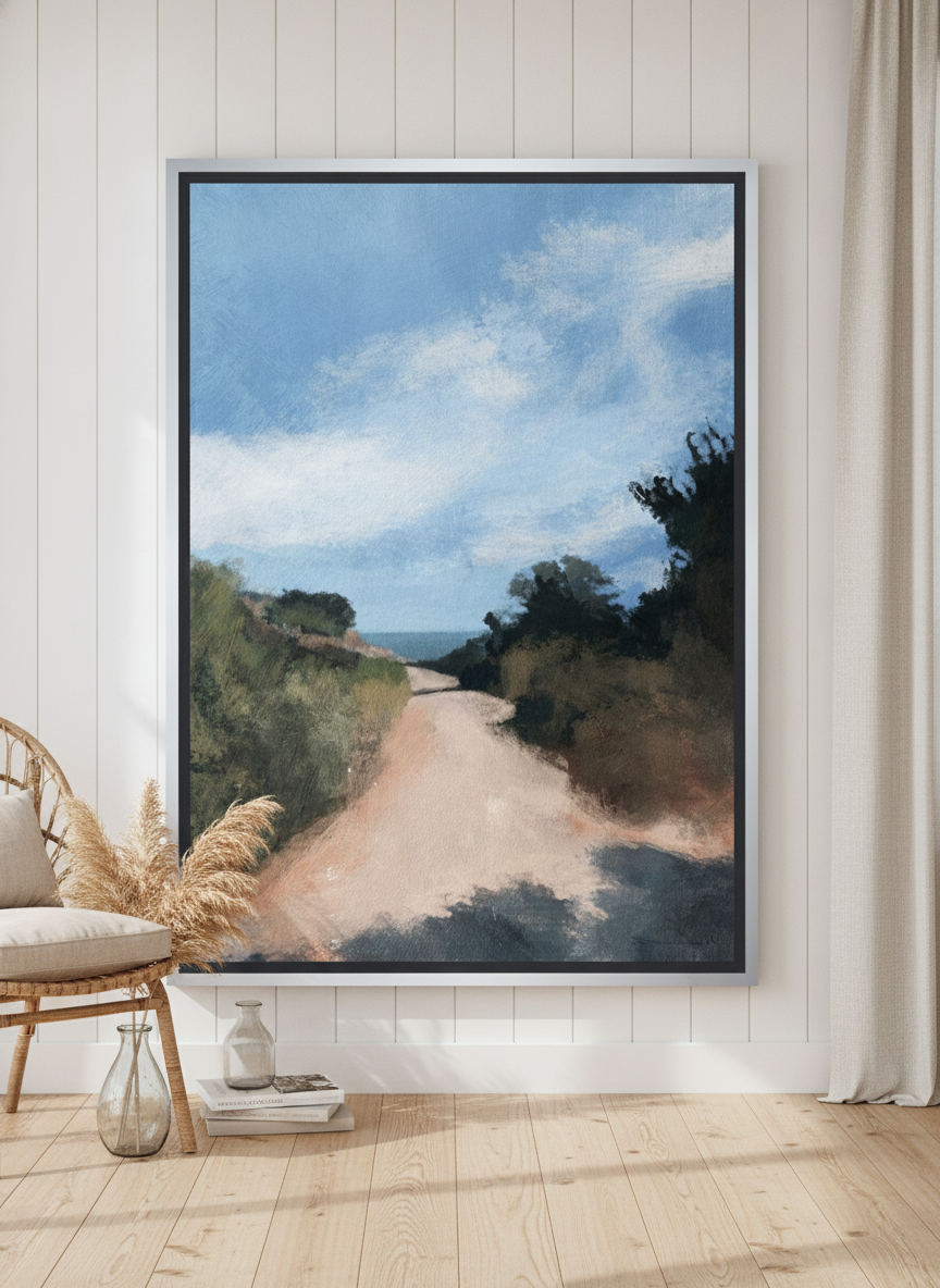 Oversized statement canvas wall art with a silver leaf surround leaning against the wall in a coastal dining room