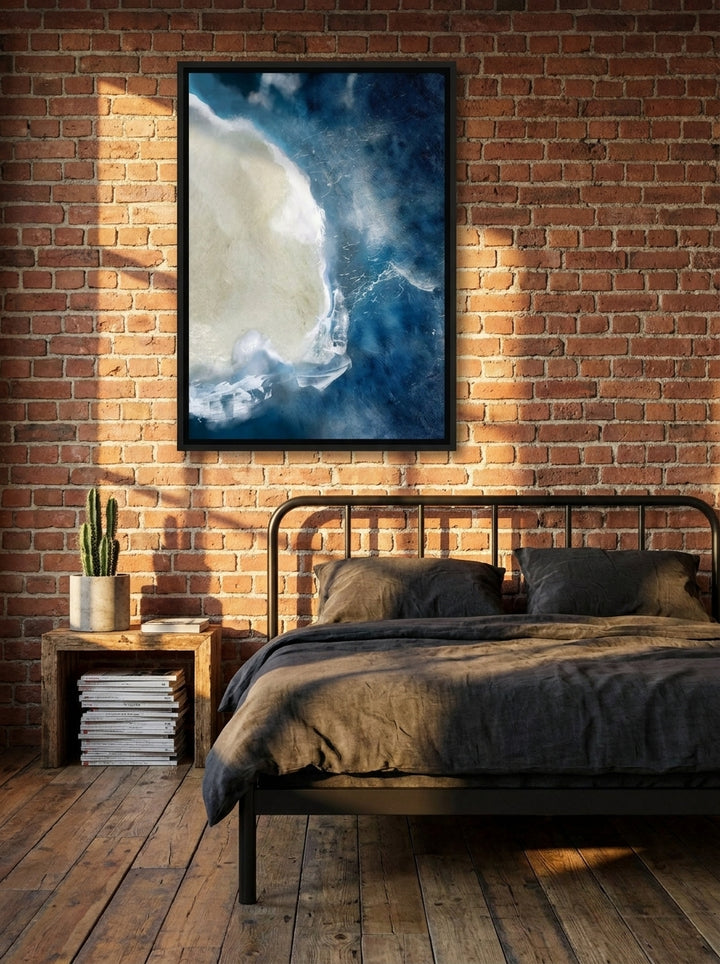 Canvas wall art with a black surround styled on the wall in an industrial loft bedroom