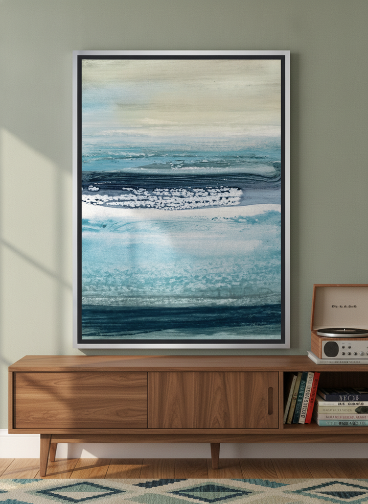 Canvas wall art with a silver leaf surround standing on a sideboard in a mid-century home office