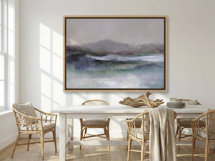 Oversized statement canvas wall art with a natural timber surround styled on the wall in a coastal dining room