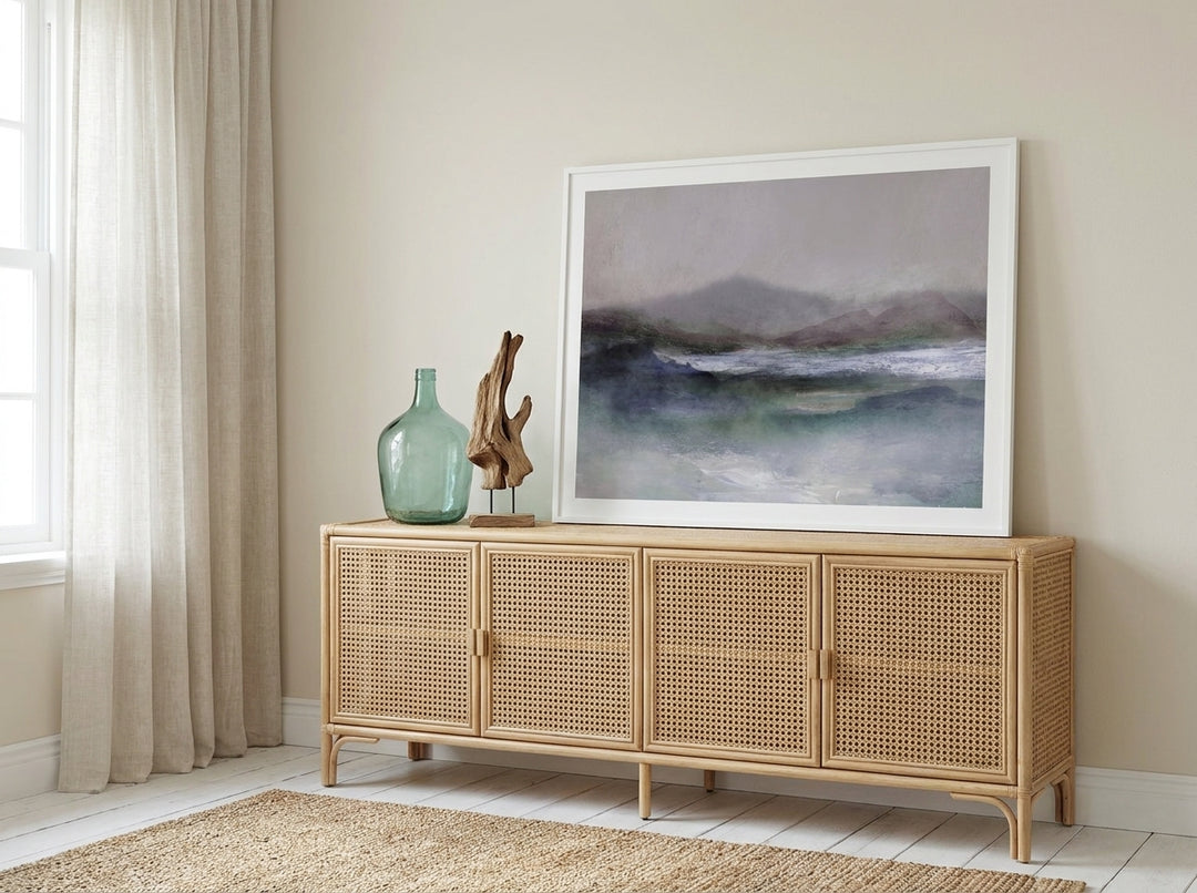 Modern wall art print standing on a sideboard in a coastal home office