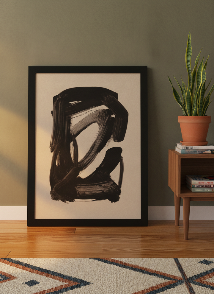Modern wall art print leaning against the wall in a mid-century living room