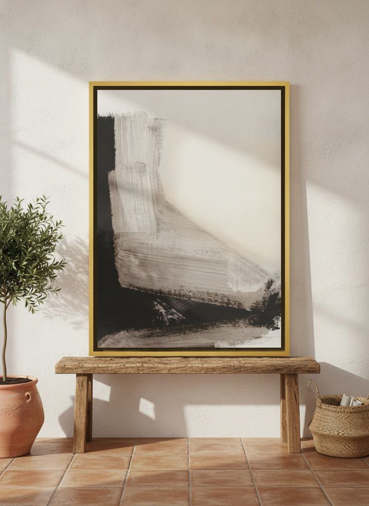 Canvas wall art with a gold leaf surround standing on a bench in a Mediterranean bedroom