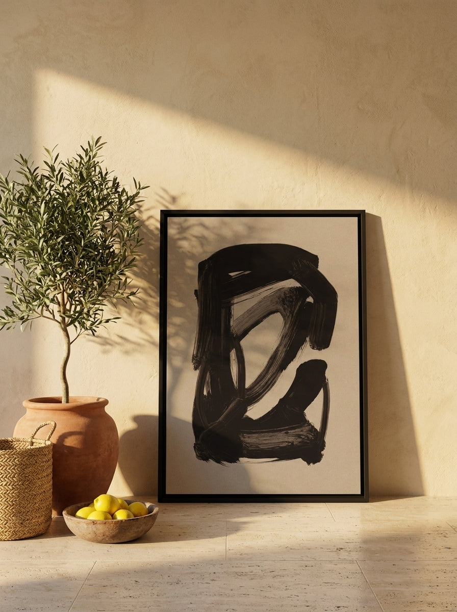 Canvas wall art with a black surround leaning against the wall in a Mediterranean living room