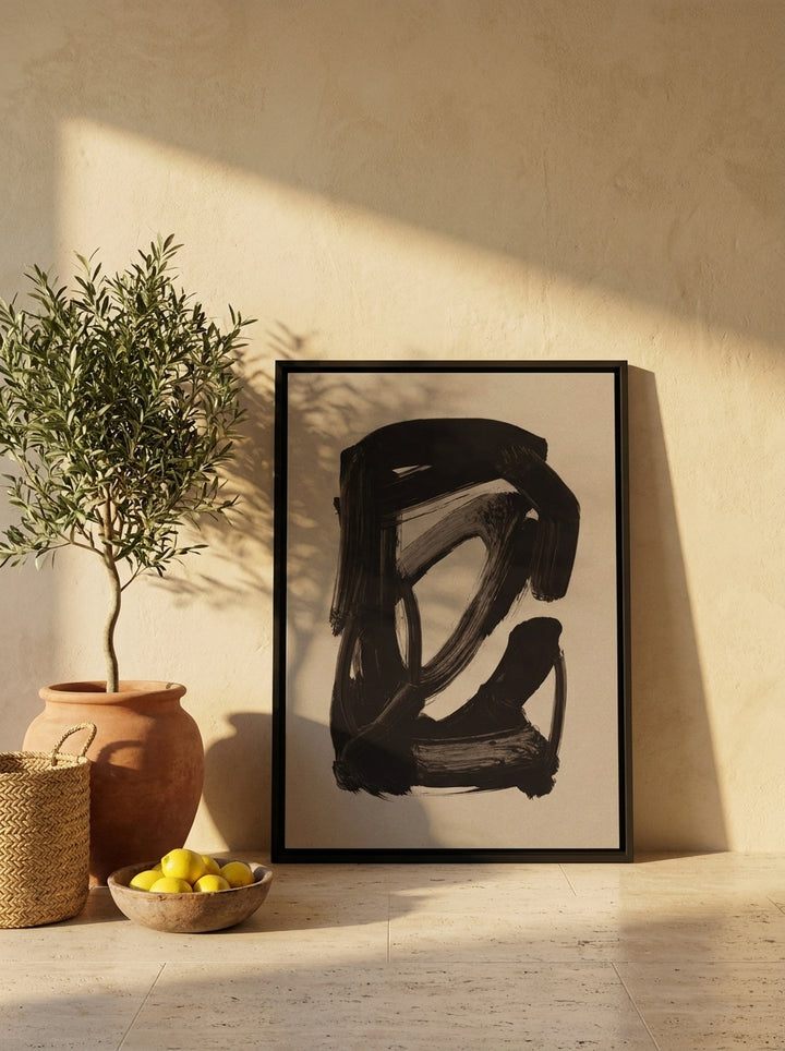 Canvas wall art with a black surround leaning against the wall in a Mediterranean living room