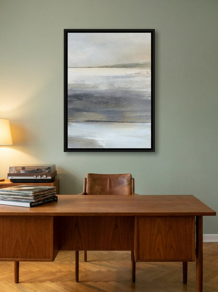 Canvas wall art with a black surround styled on the wall in a mid-century home office