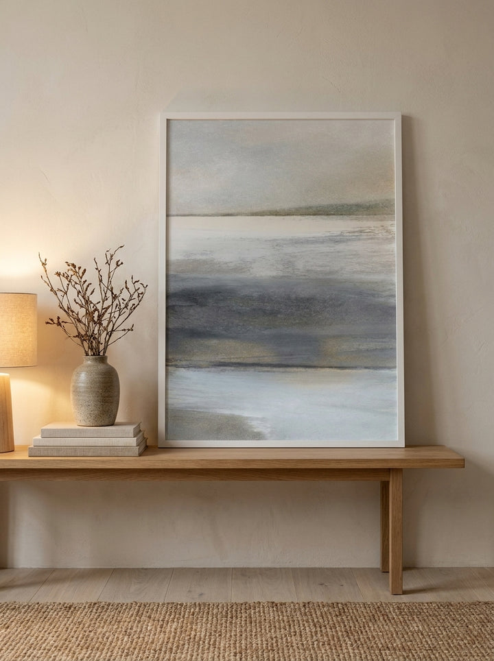 Modern wall art print standing on a bench in a warm Japandi bathroom