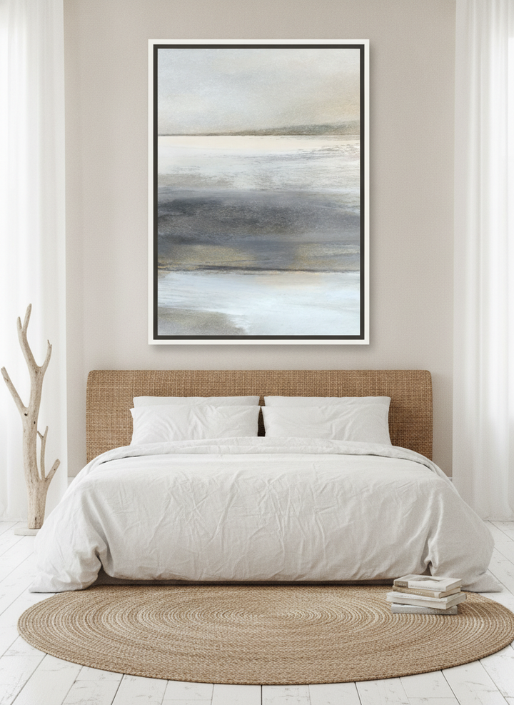 Oversized statement canvas wall art with a white surround styled on the wall in a coastal bedroom