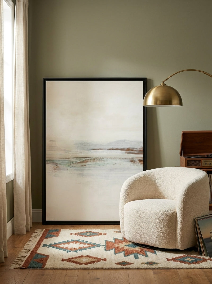 Canvas wall art with a black surround leaning against the wall in a mid-century home office