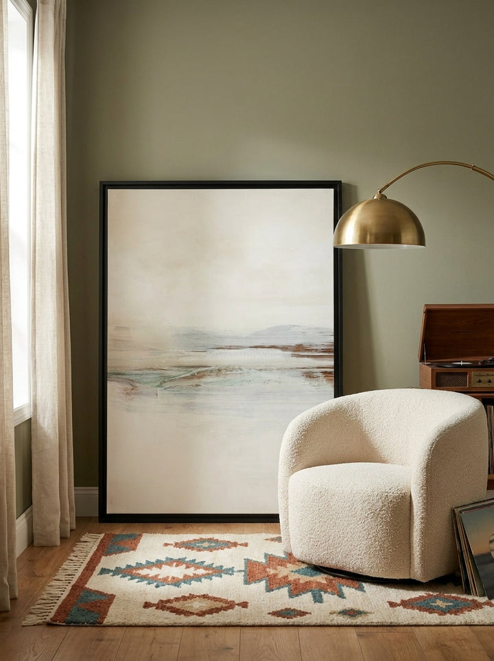 Canvas wall art with a black surround leaning against the wall in a mid-century home office