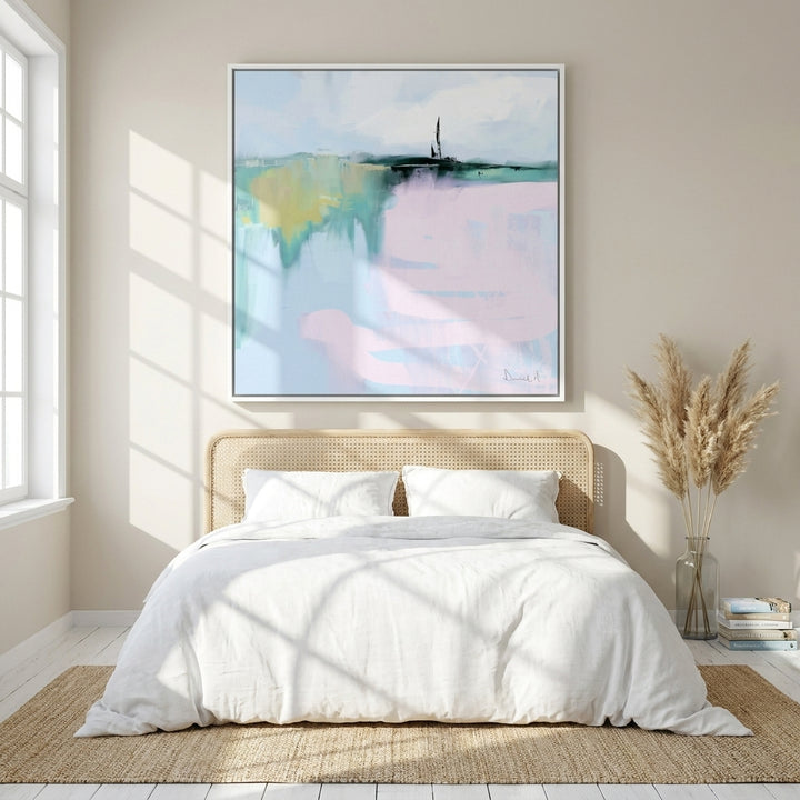 Oversized statement canvas wall art with a white surround styled on the wall in a coastal bedroom