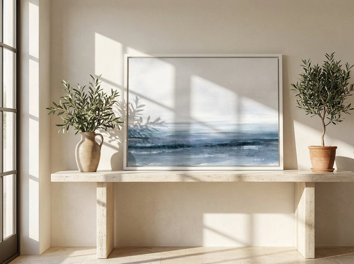 Canvas wall art with a white surround standing on a console in a Mediterranean dining room