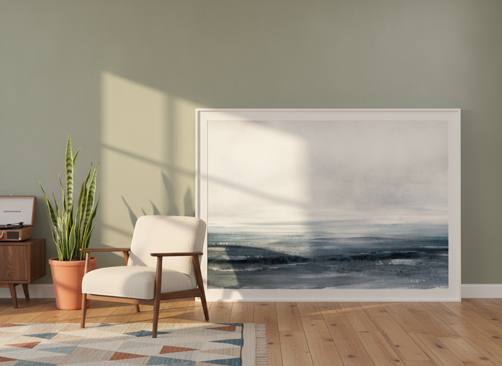 Oversized statement modern wall art print leaning against the wall in a mid-century living room