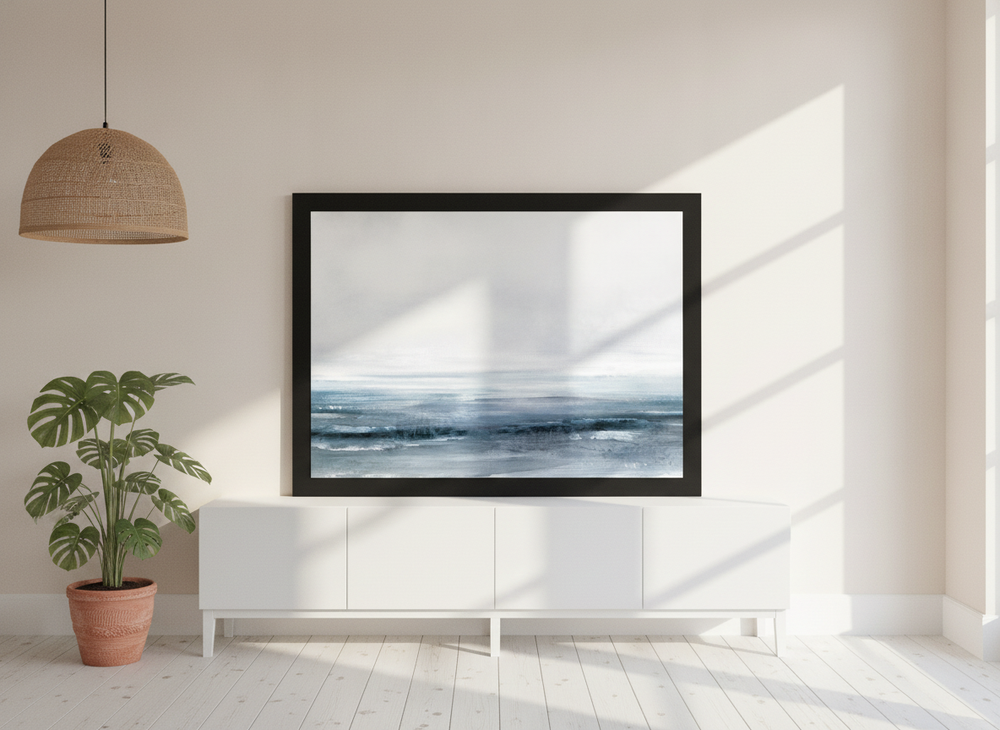 Modern wall art print standing on a sideboard in a bright Scandinavian bedroom