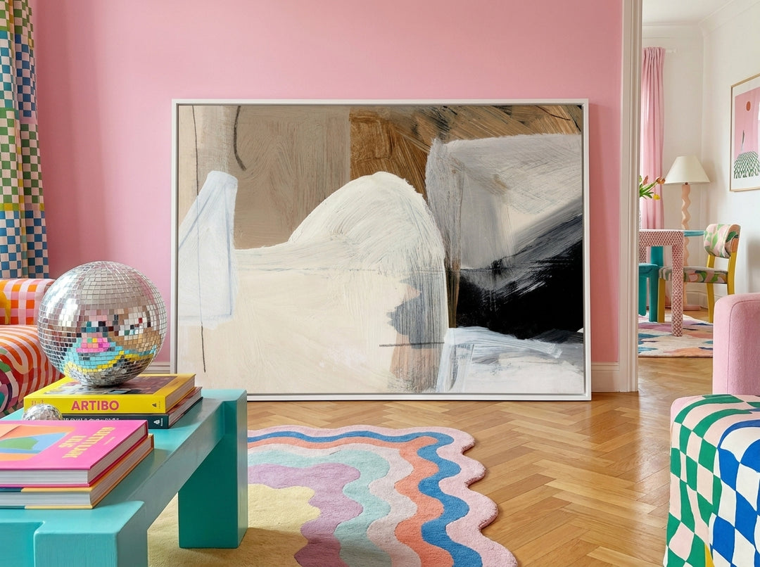 Canvas wall art with a white surround standing on a side table in a colourful eclectic bedroom