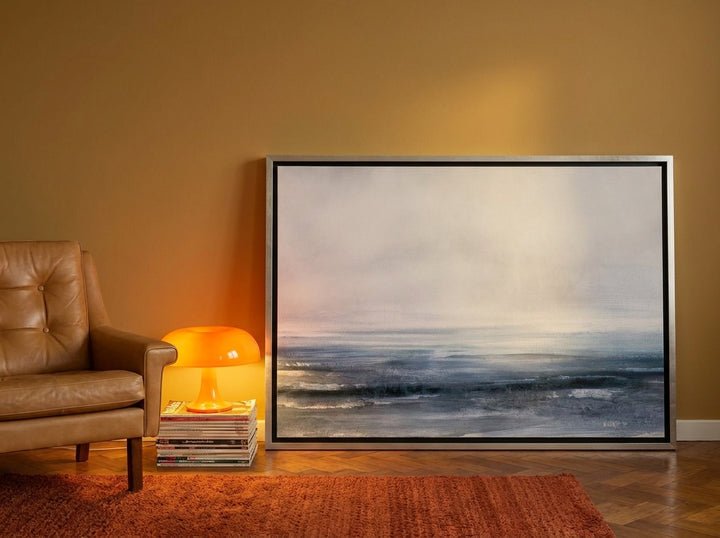 Canvas wall art with a silver leaf surround leaning against the wall in a retro 70s bedroom