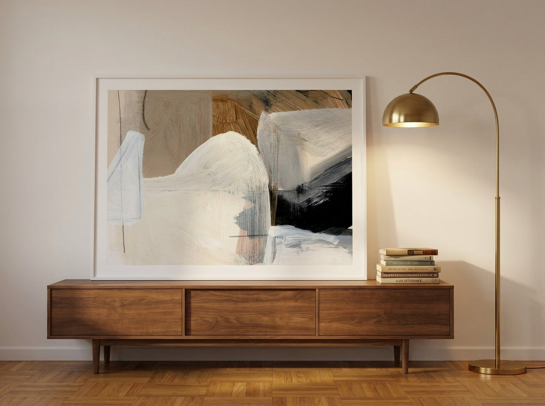Modern wall art print standing on a sideboard in a mid-century home office
