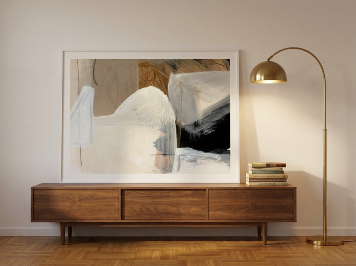 Modern wall art print standing on a sideboard in a mid-century home office