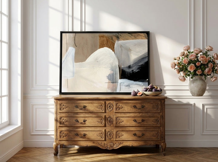 Canvas wall art with a black surround standing on a sideboard in a Parisian living room