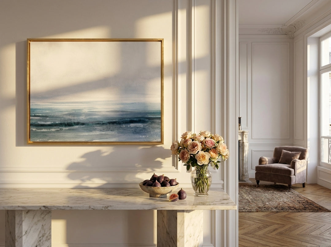 Oversized statement canvas wall art with a gold leaf surround styled on the wall in a Parisian living room