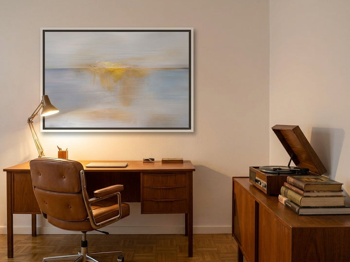 Canvas wall art with a white surround styled on the wall in a mid-century home office
