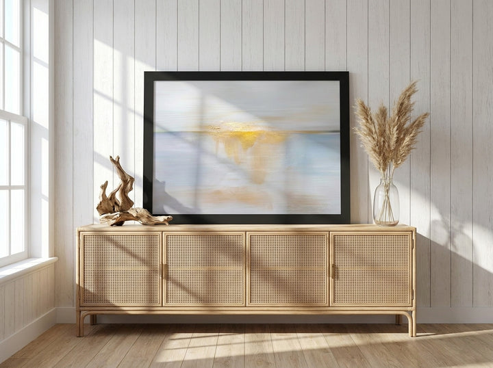 Modern wall art print standing on a sideboard in a coastal bedroom
