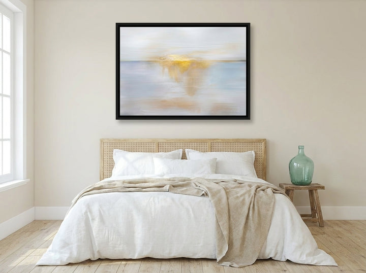 Canvas wall art with a black surround styled on the wall in a coastal bedroom