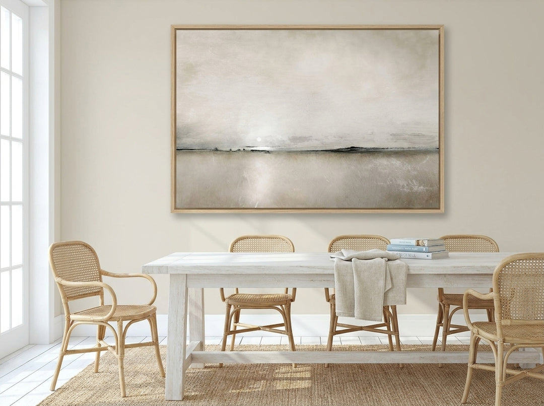 Oversized statement canvas wall art with a natural timber surround styled on the wall in a coastal dining room