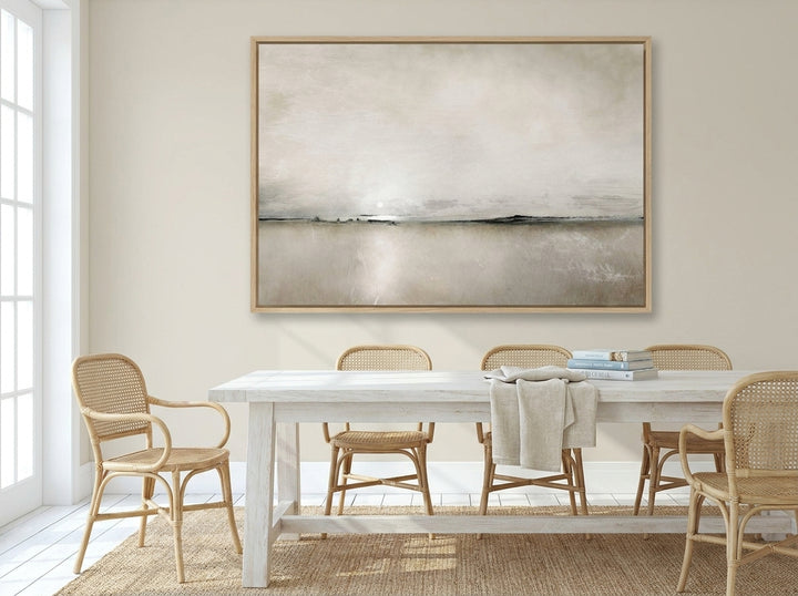 Oversized statement canvas wall art with a natural timber surround styled on the wall in a coastal dining room